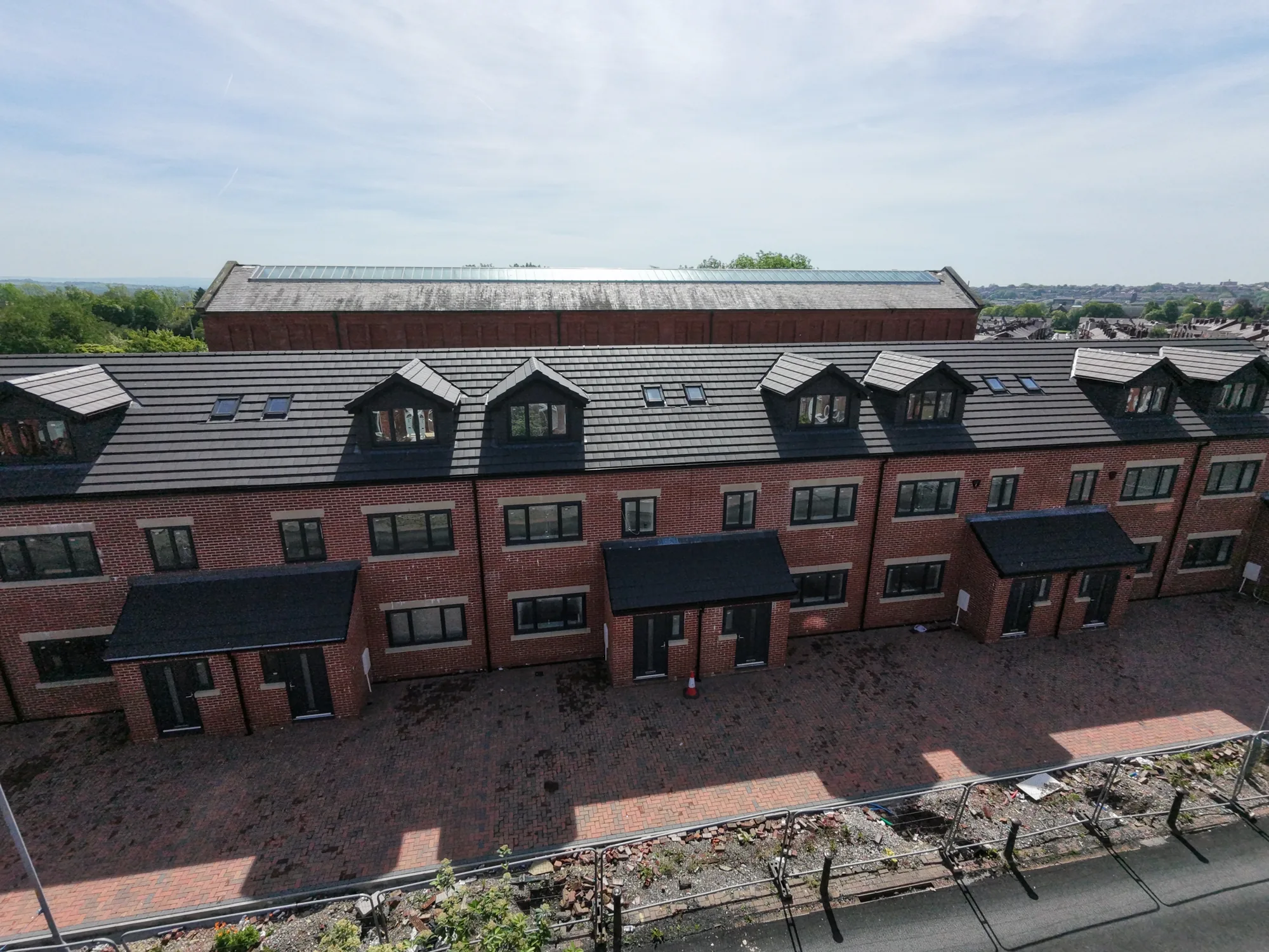 Consistent tiled roofing across multiple new-build plots
