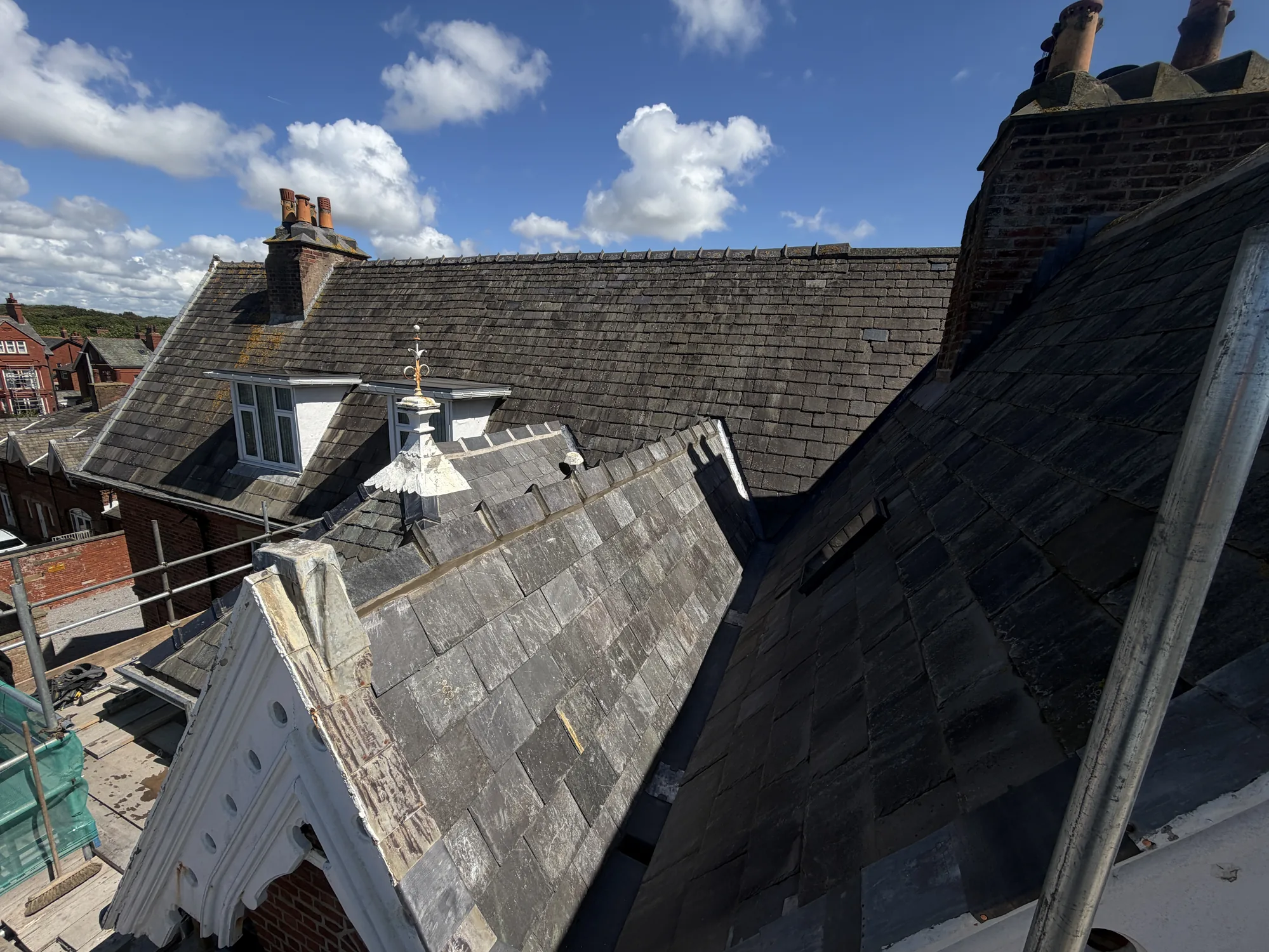 Decorative slate roof with an ornate finial and gable detailing