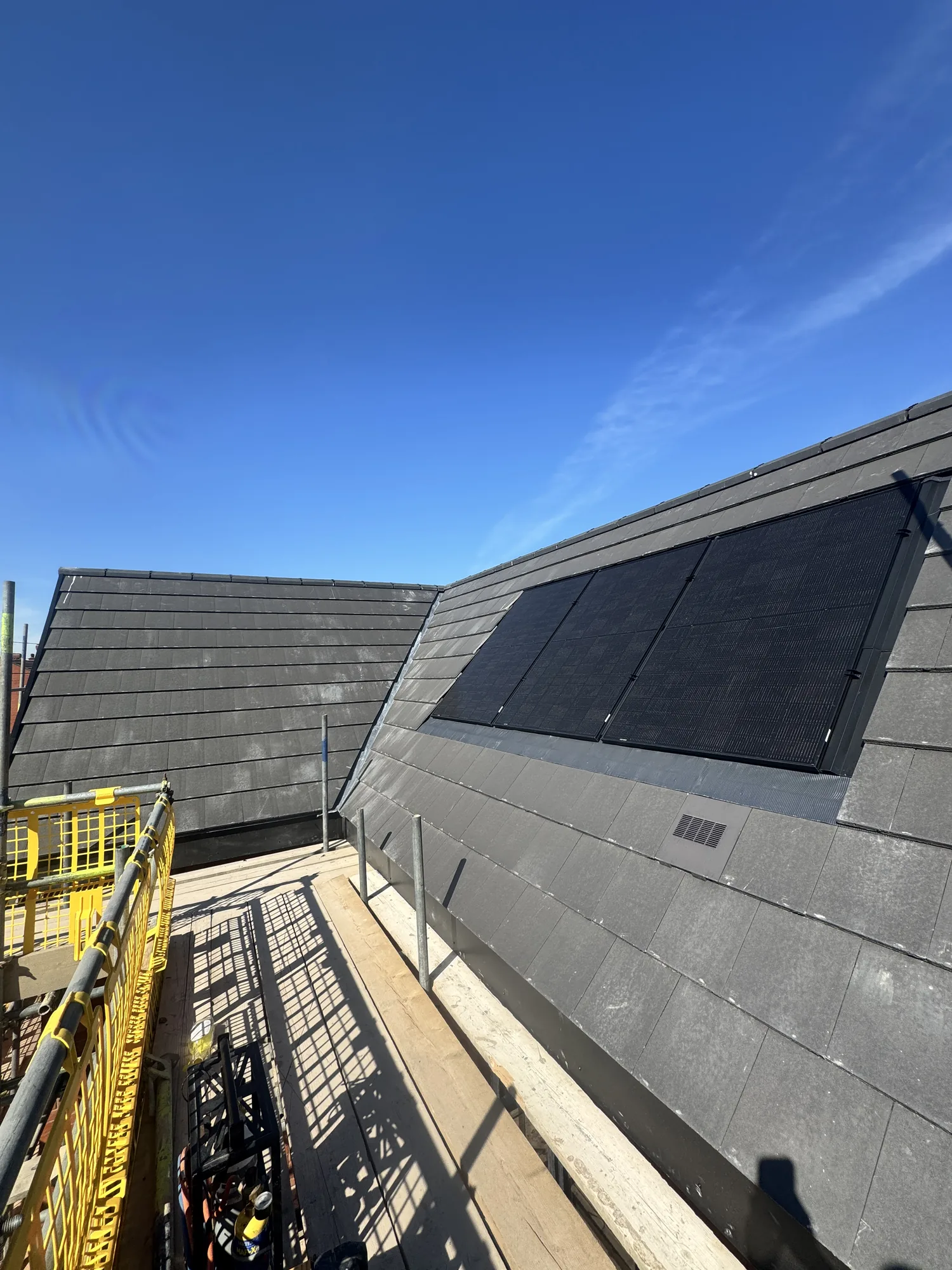 Integrated solar panels on a new tiled roof from the scaffold